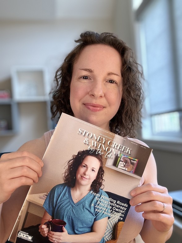 Ashley Talbot holding copy of magazine she is featured in